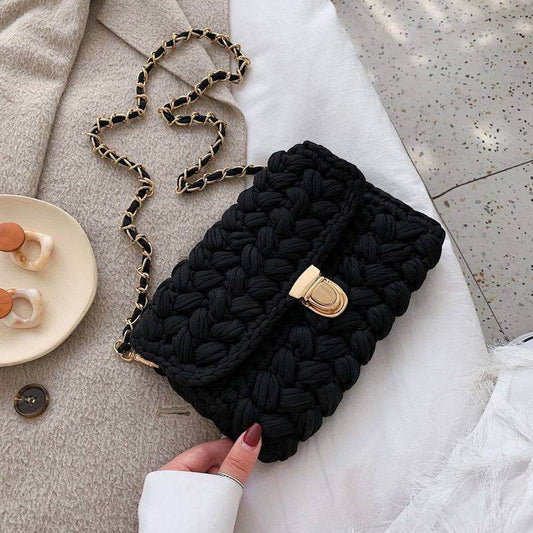 Elegant handwoven black chunky knit bag with gold chain strap 